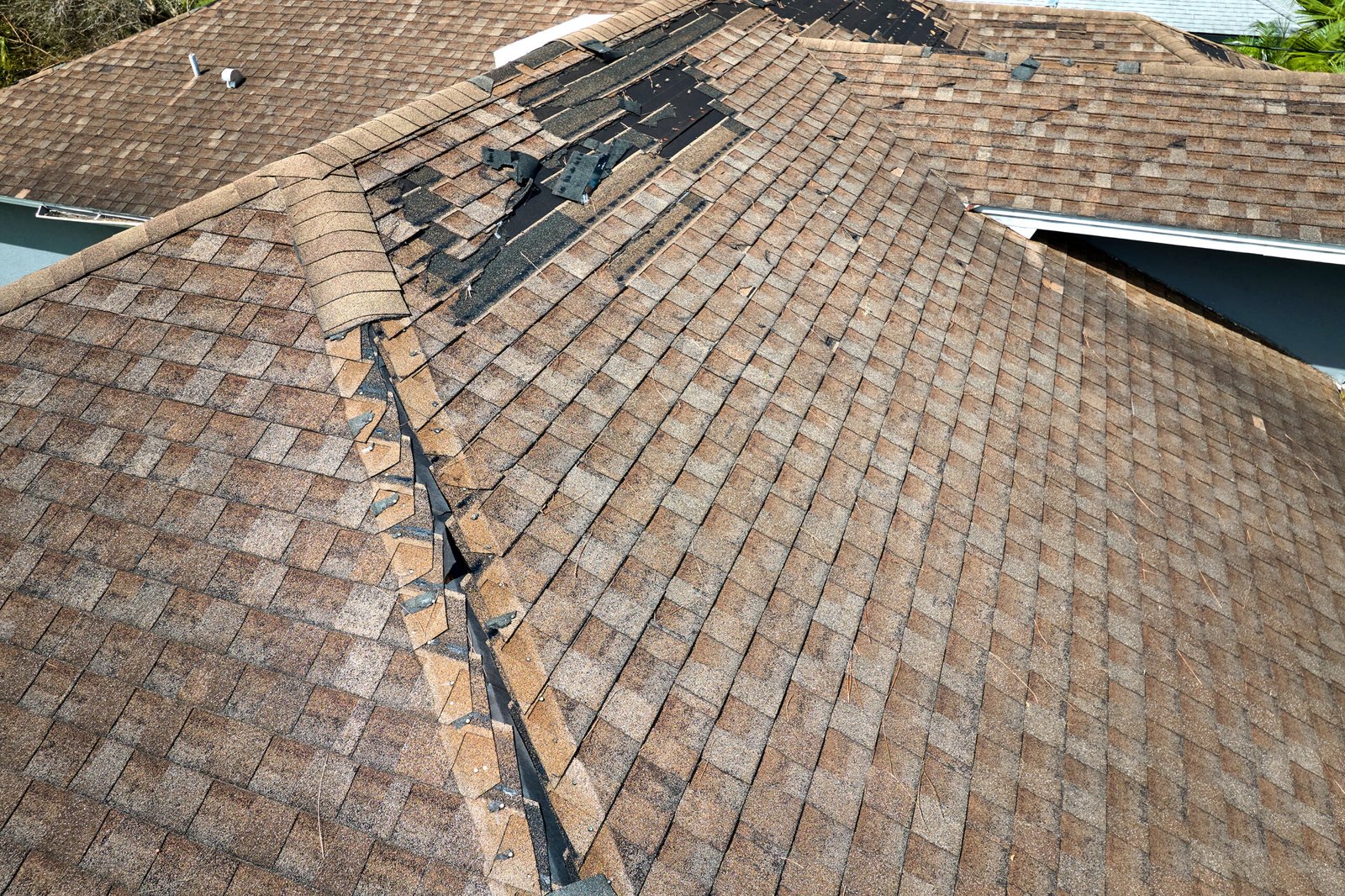 ajax-roof-repair Wind damaged house roof in Ajax with missing asphalt shingles missing that needs to be repaired