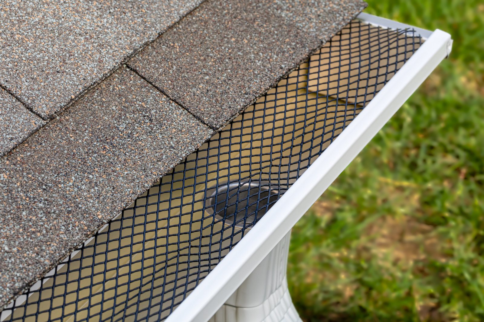 Roofer Installing gutter leaf guard mesh screen on rain guttering on house in Ajax